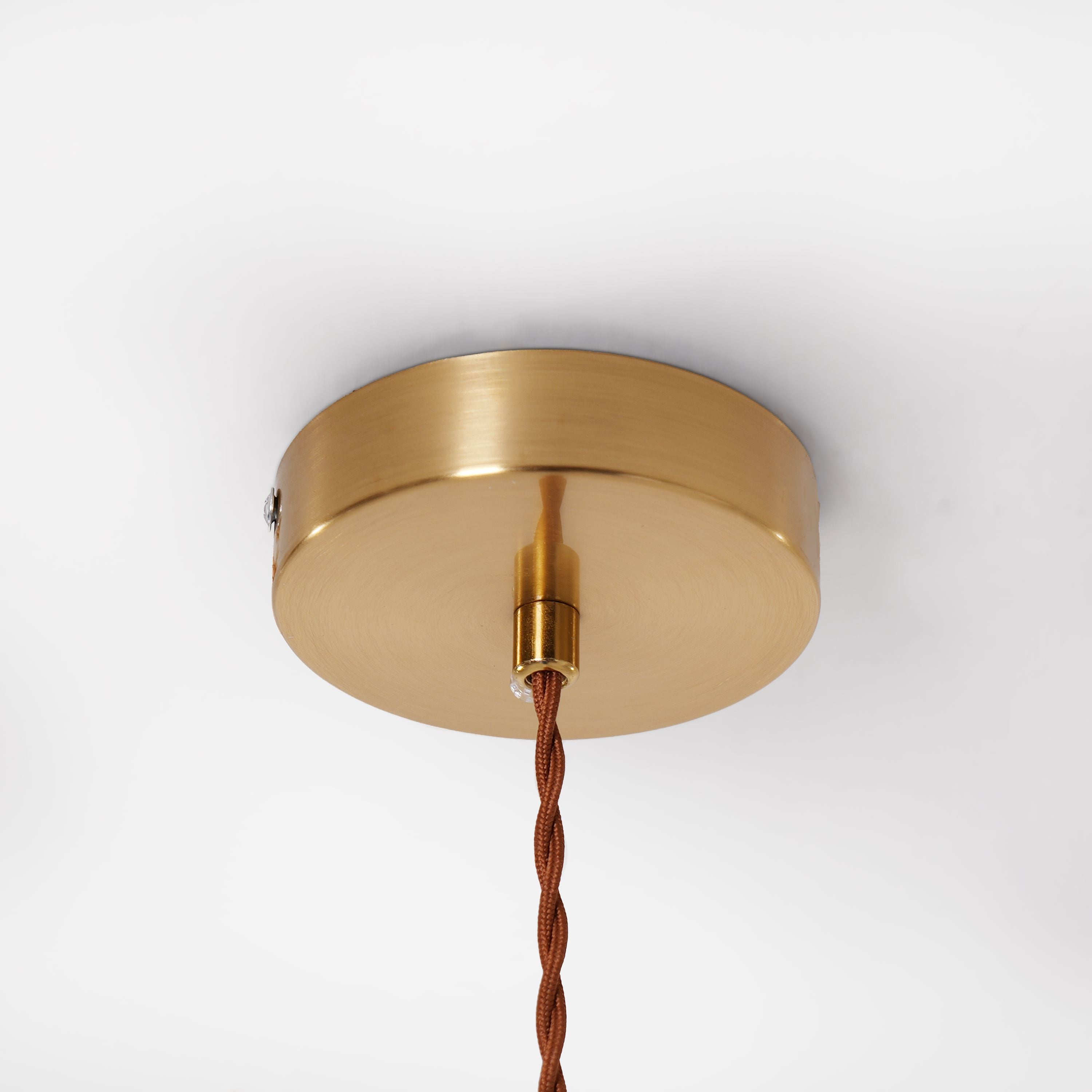 brown ceramic lace pendant light beside a cosy seating area