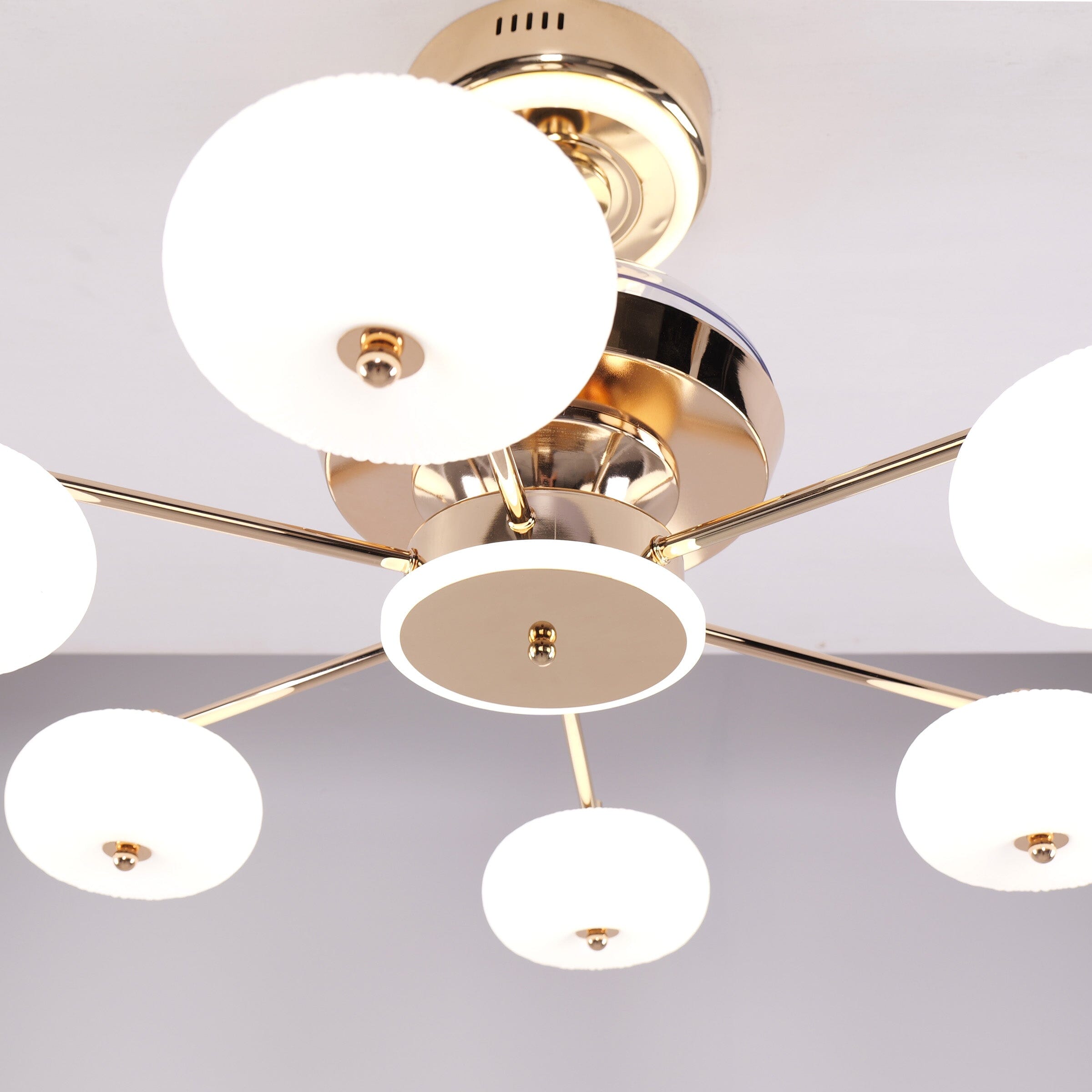 Close-up of copper ceiling fan light with acrylic globe shades and central fan