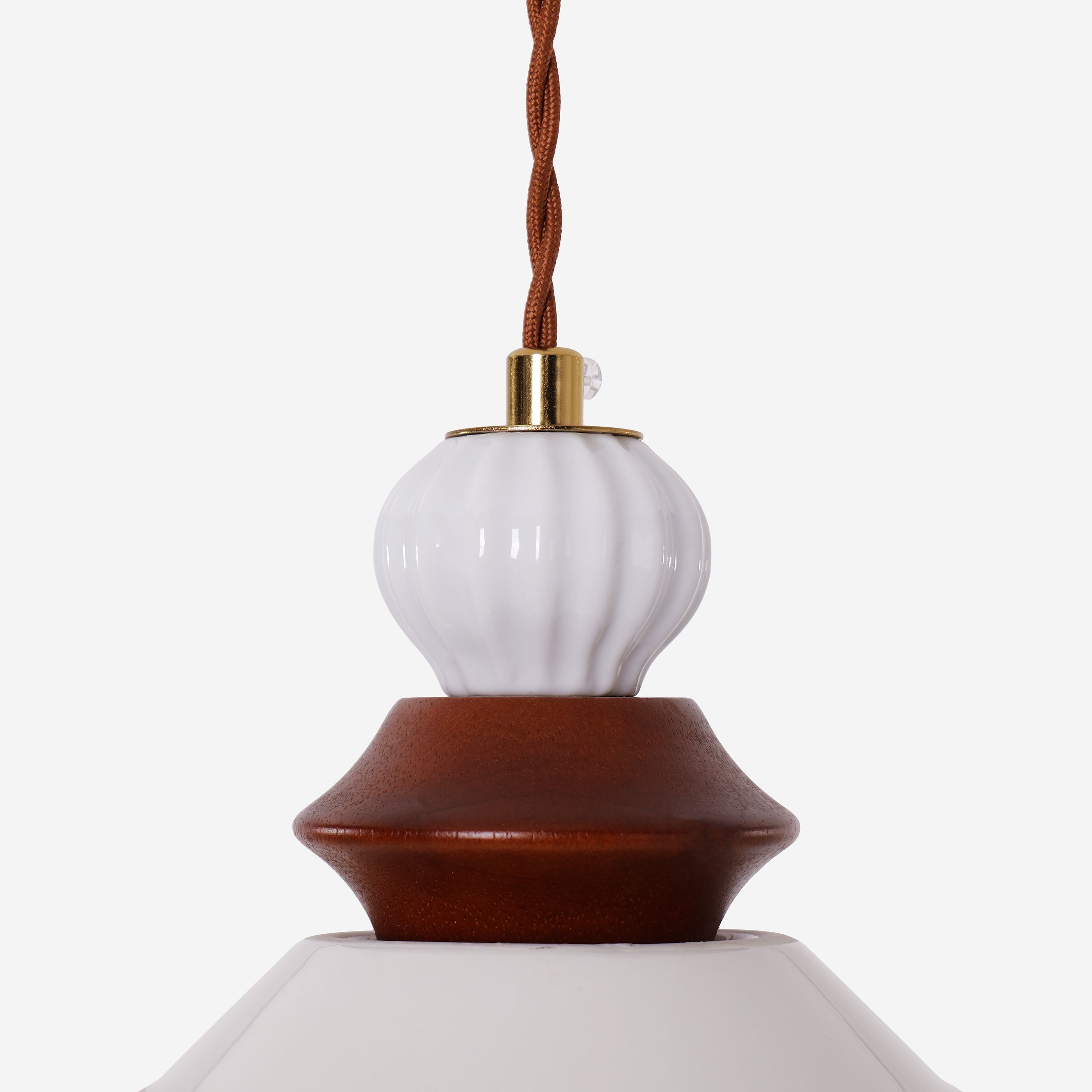 brown ceramic lace pendant light adding warm light to a dining space