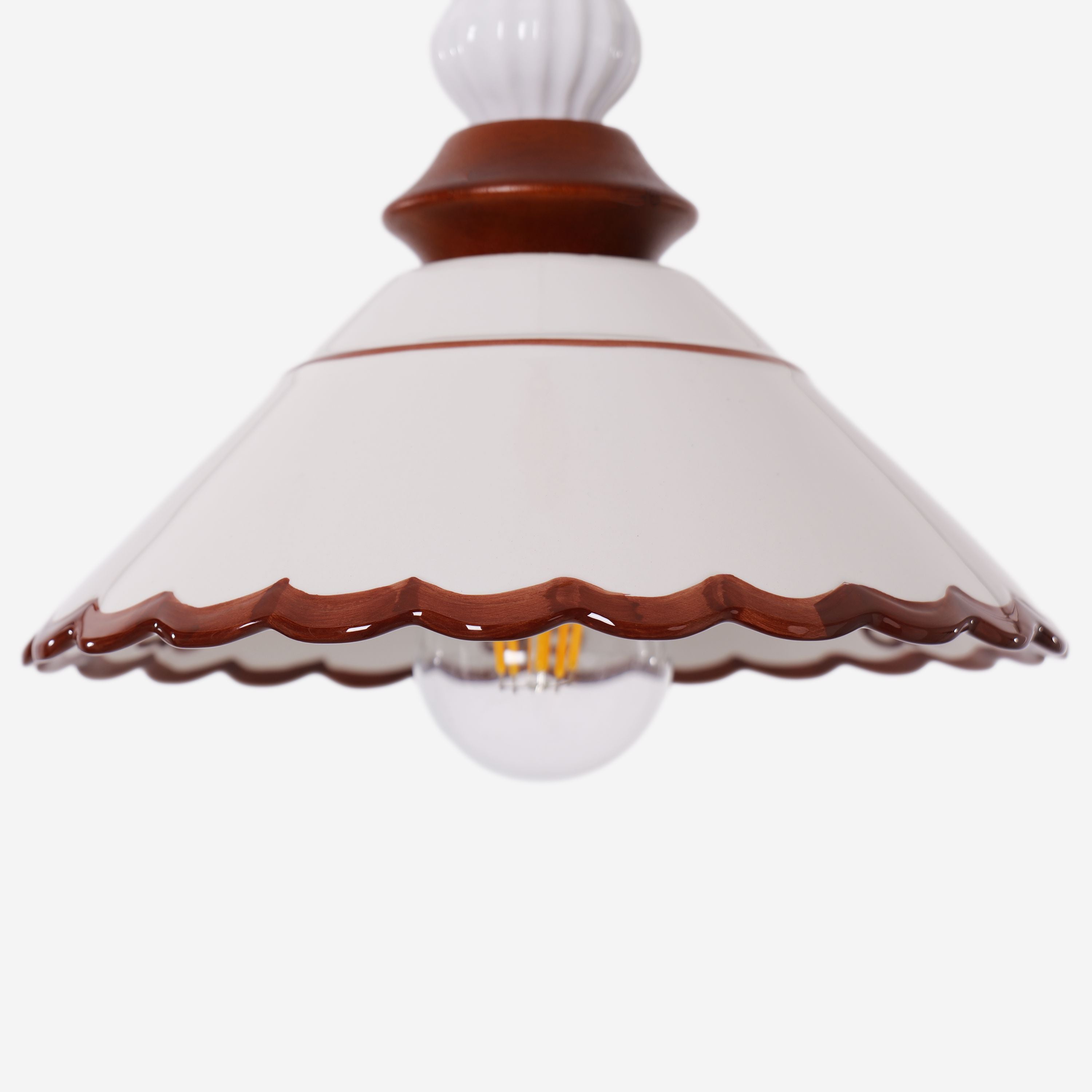 brown ceramic lace pendant light hung above a dining table