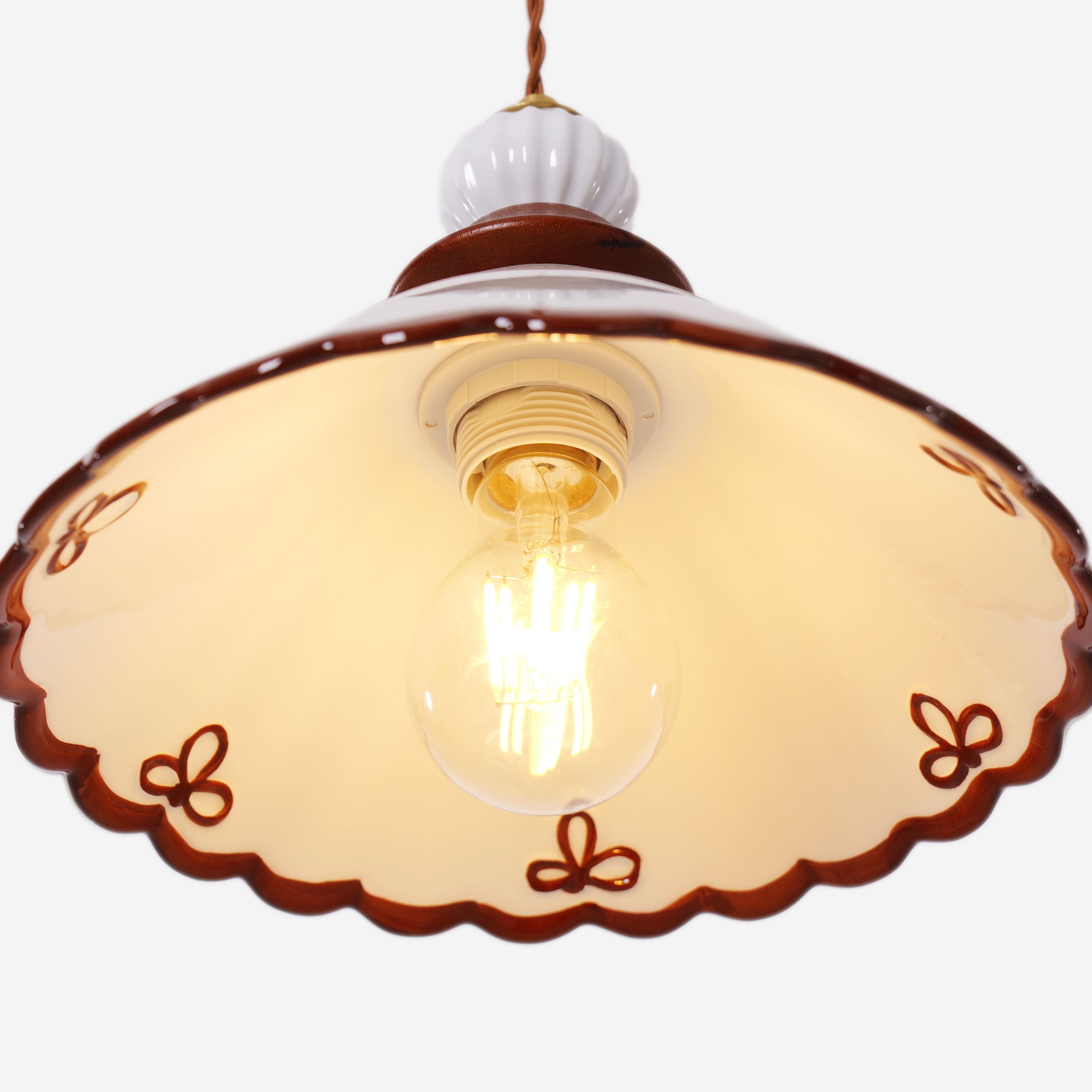 brown ceramic lace pendant light styled in a calm bedroom