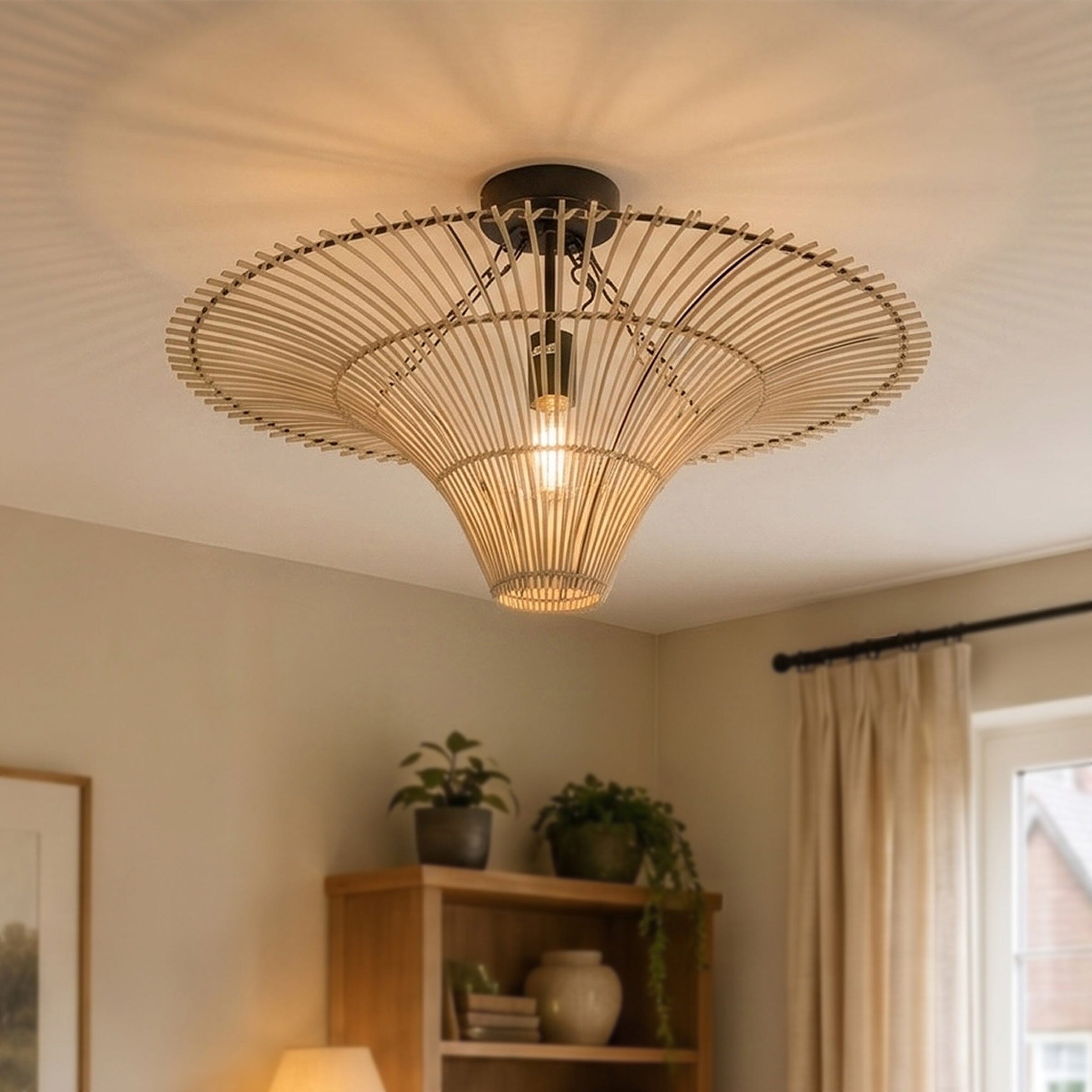Flying saucer rattan ceiling light casting a warm glow in a cosy living room