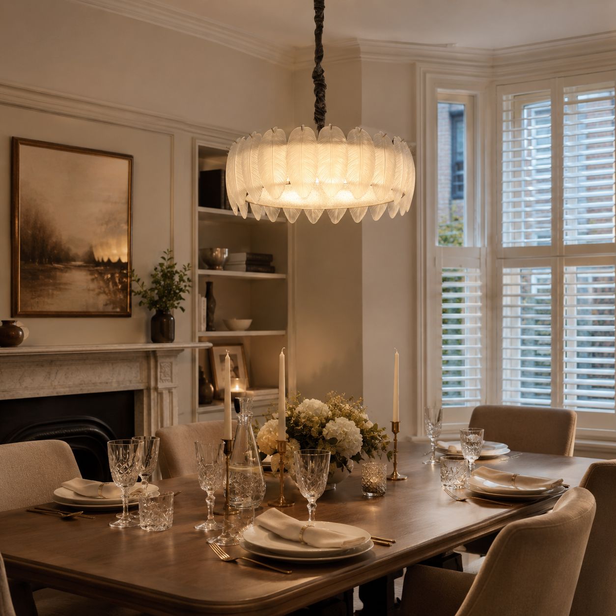 feather inspired glass chandelier above a dining table with soft warm light