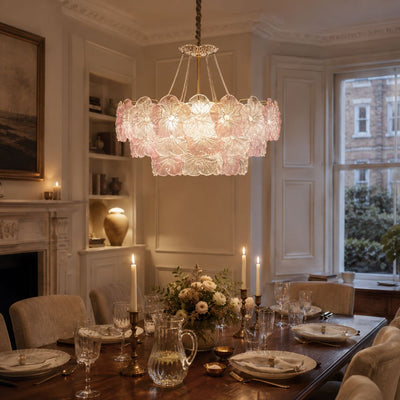 pink glass flower chandelier above a dining table in a warm living room