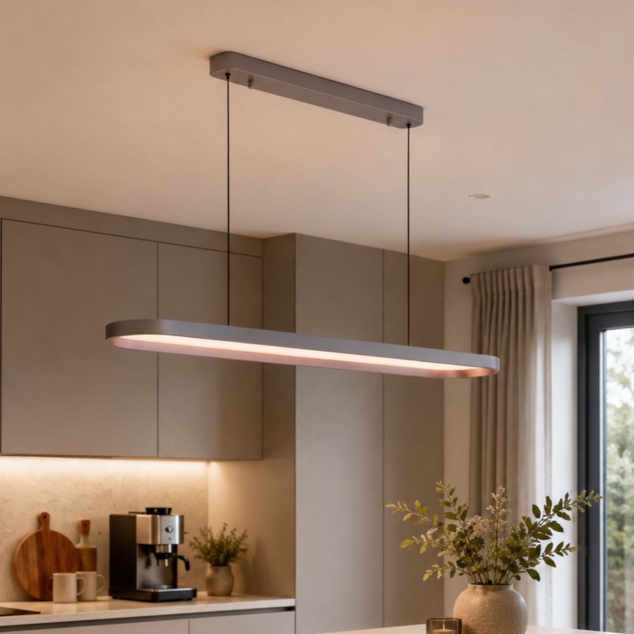 gray-brown elliptical pendant light above a kitchen island