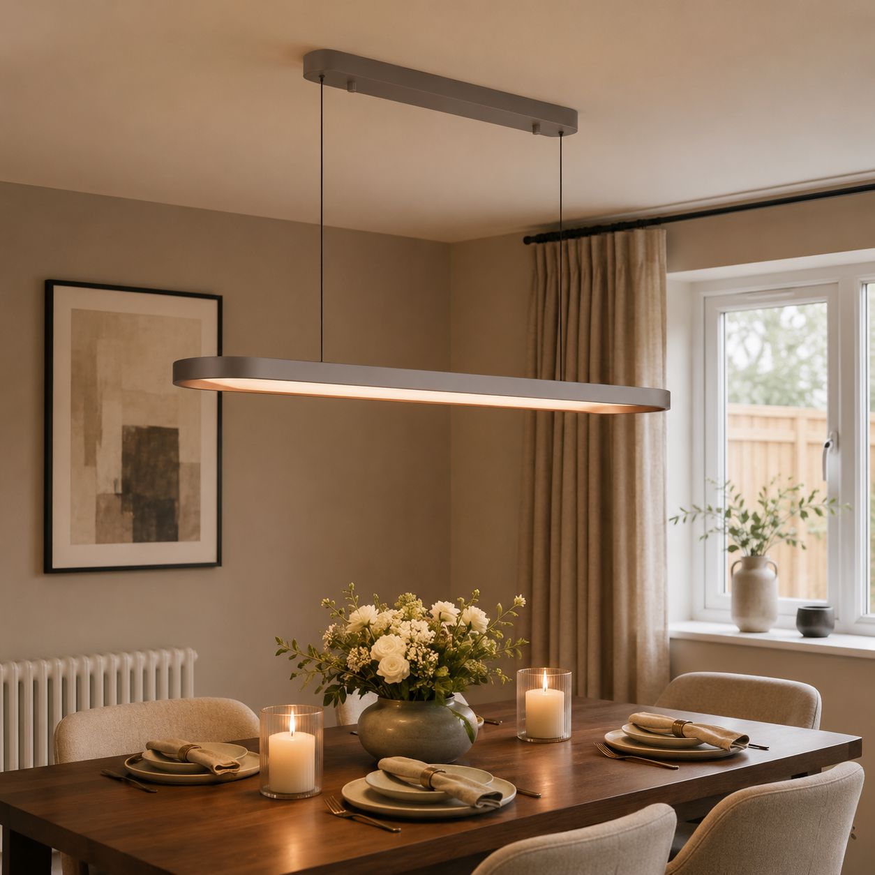 elliptical dimmable pendant above a round dining table