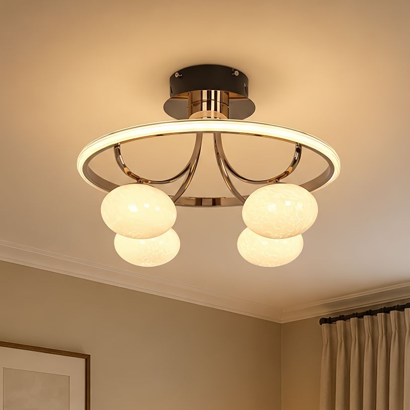 gold circular ceiling light with four globe shades in a bedroom