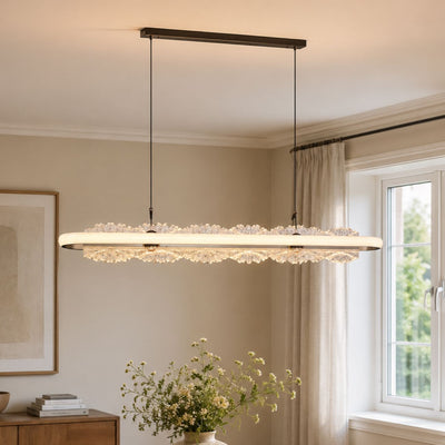 linear aluminum and acrylic pendant light beside a bright dining window