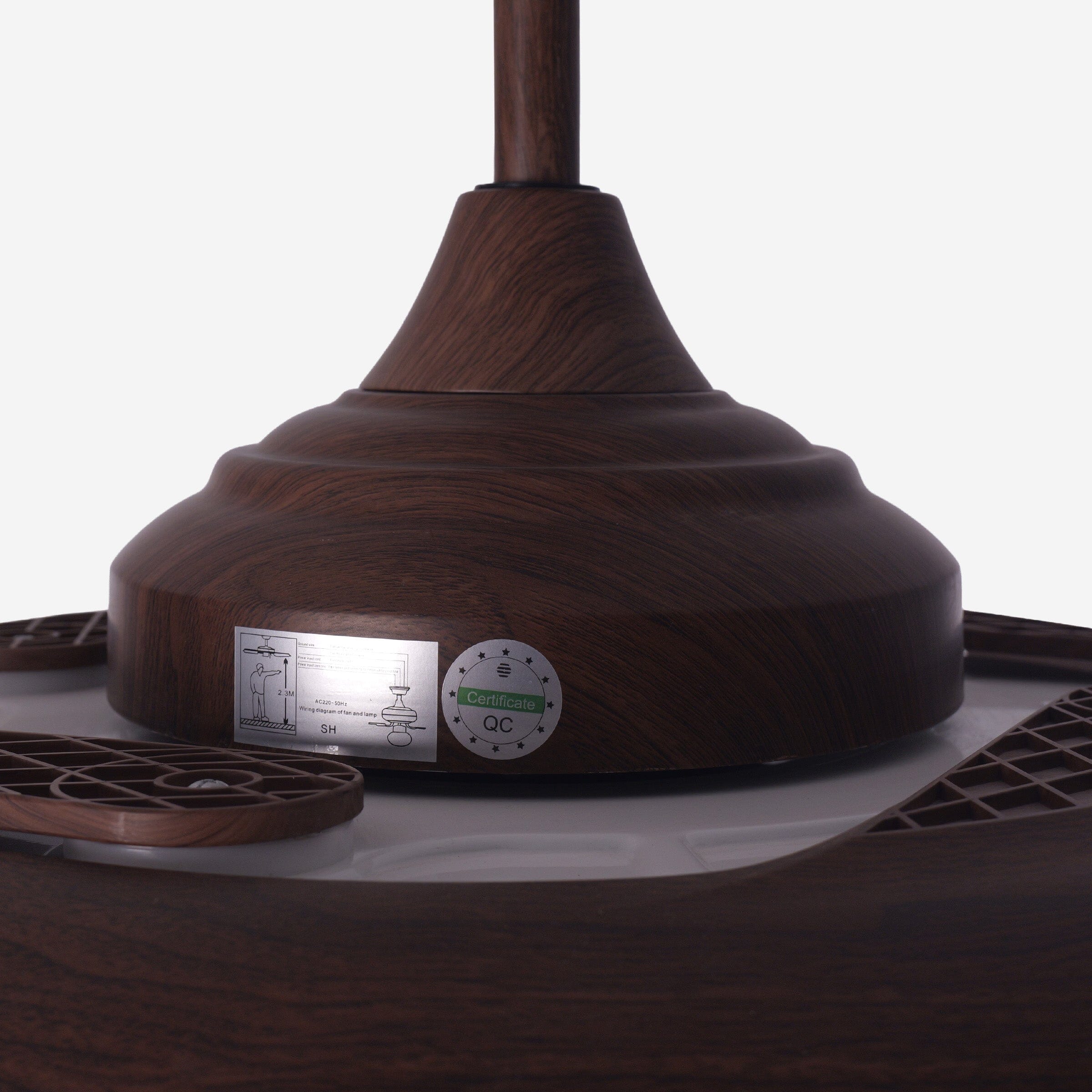 Close-up of walnut effect fan motor housing and control components