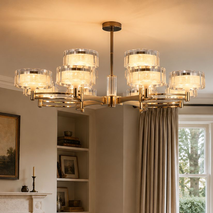 gold metal chandelier with clear drum shades in a living room